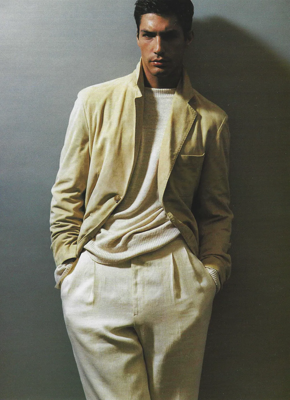 Nacho Valenti Lacroix in a Salvatore Ferragamo linen jacket and pleated trousers against a grey wall